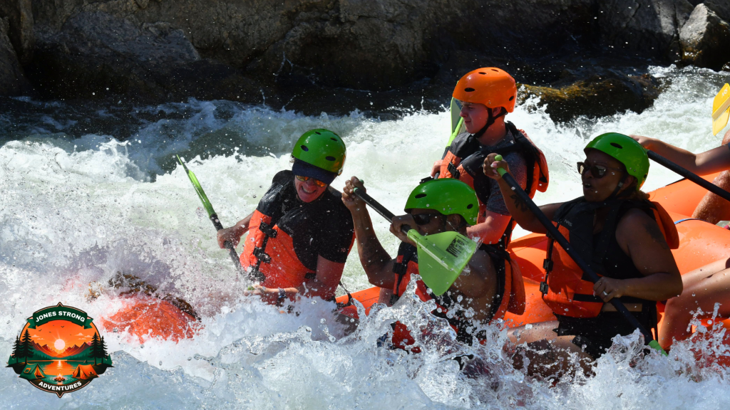 Group of people in life jackets and helmets rafting through rough white-water rapids with intense expressions.