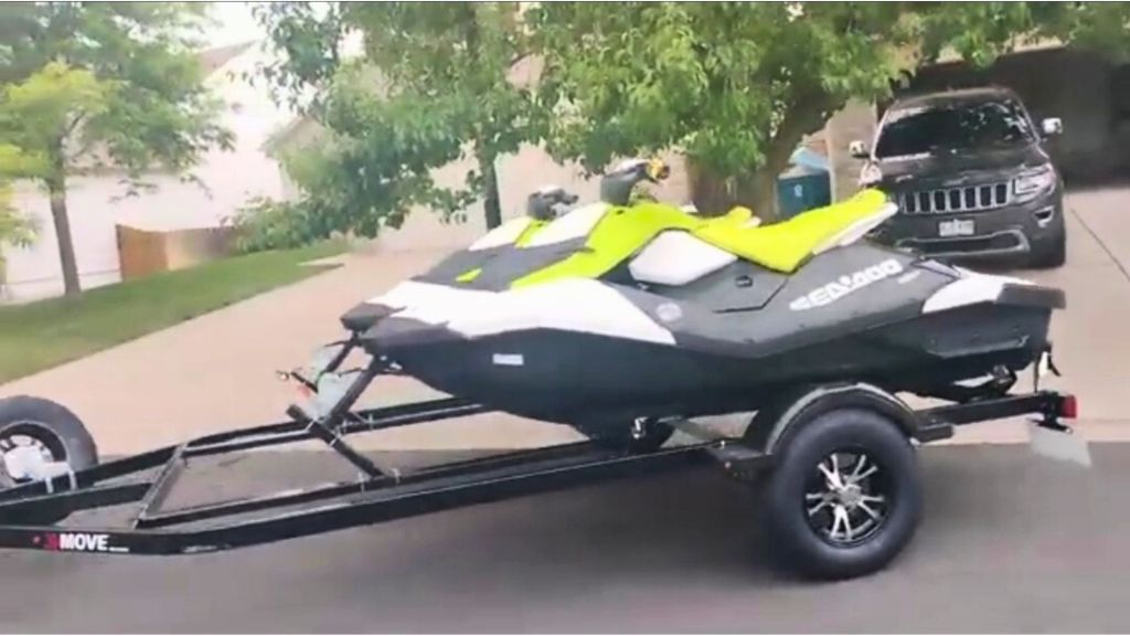 Jet ski on a trailer parked in a residential area.